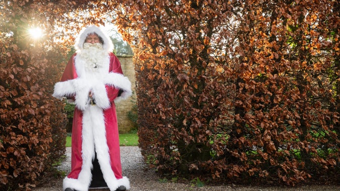 Father Christmas stood in the beech hedge at Nunnington Hall